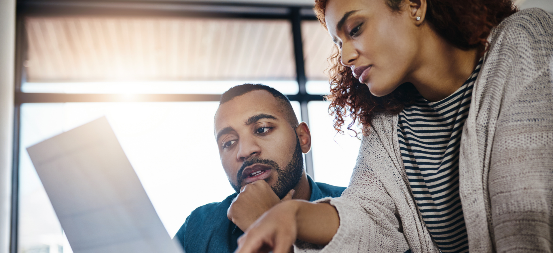 Diverse team collaborating on community resilience strategies indoors.
